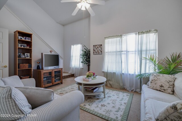 living room with high vaulted ceiling, carpet, plenty of natural light, and ceiling fan