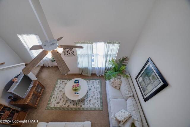 living room featuring carpet and ceiling fan