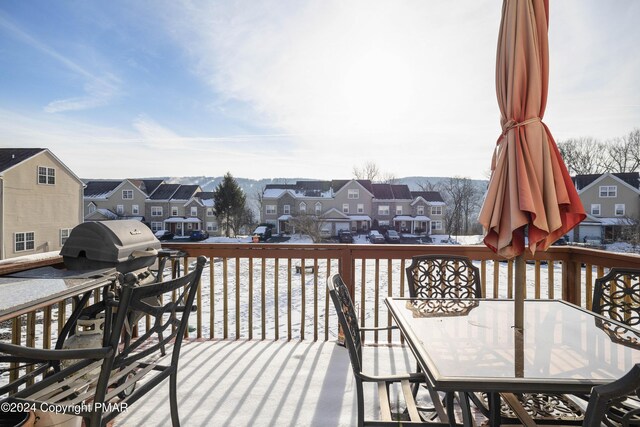 wooden deck with outdoor dining space and a residential view