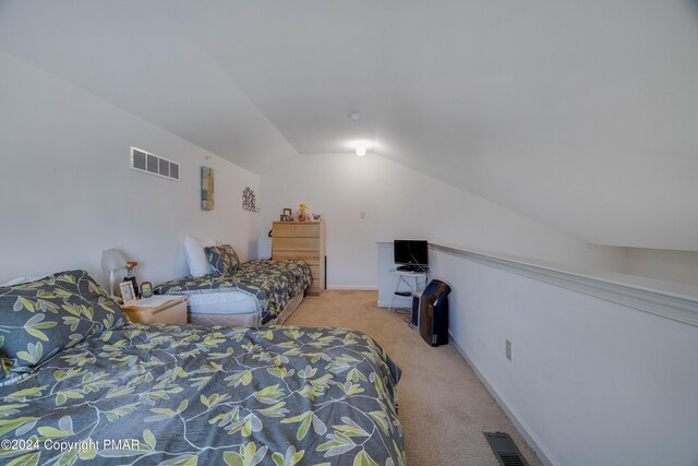 bedroom with visible vents, vaulted ceiling, light carpet, and baseboards