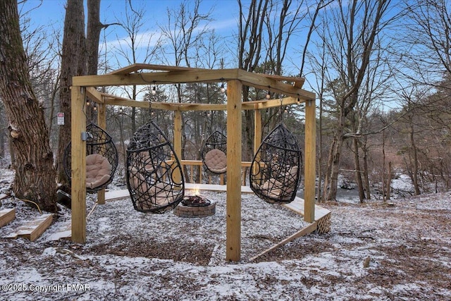 snowy yard with an outdoor fire pit