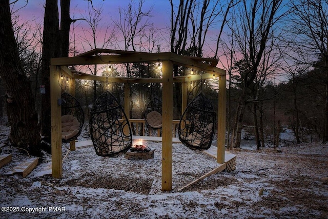 snowy yard featuring an outdoor fire pit