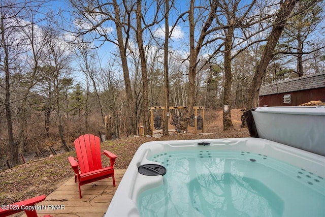 view of swimming pool with a hot tub