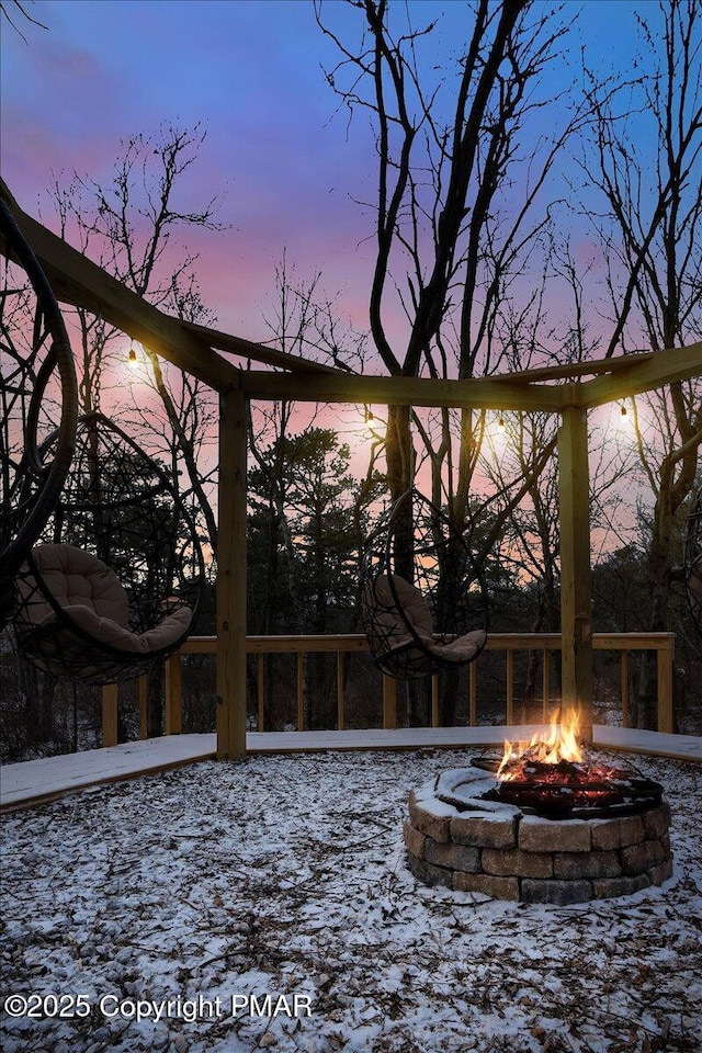 snowy yard with an outdoor fire pit