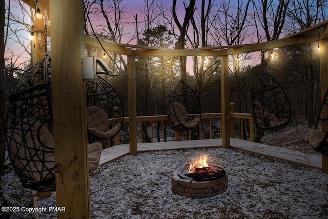 patio terrace at dusk featuring a fire pit