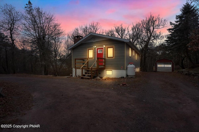 view of front of home featuring a garage and an outdoor structure