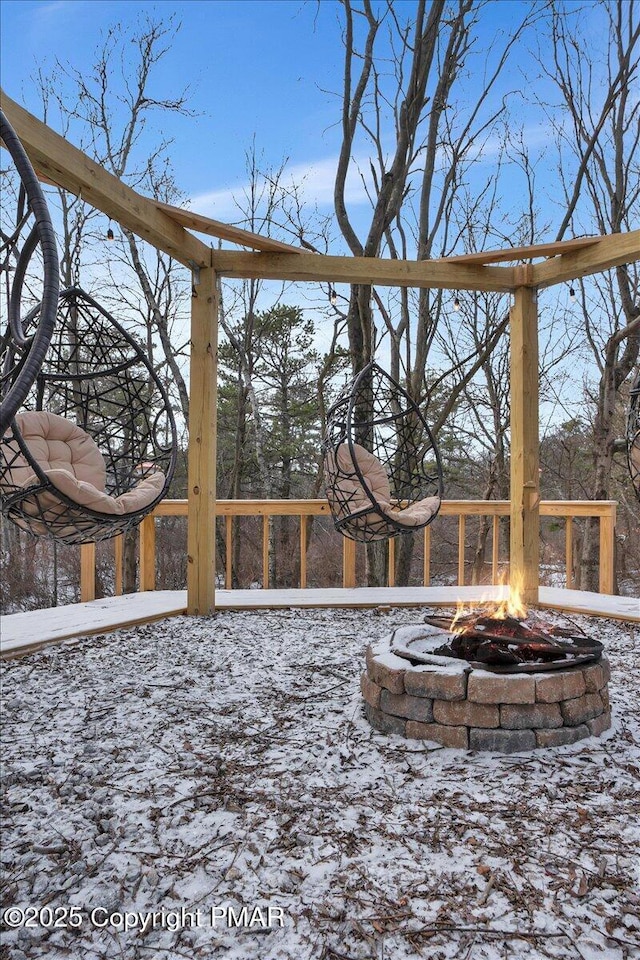 yard covered in snow with an outdoor fire pit