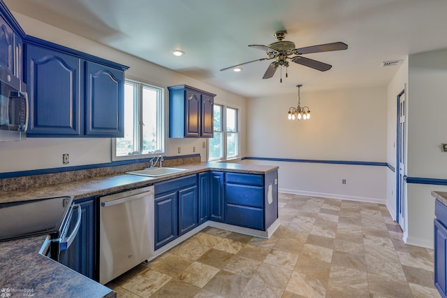 kitchen with a peninsula, a sink, ceiling fan with notable chandelier, dishwasher, and blue cabinetry