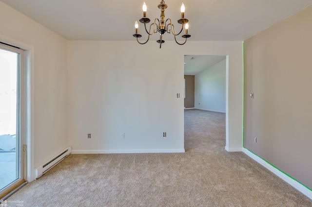 unfurnished room with carpet floors, baseboards, a chandelier, and a baseboard radiator