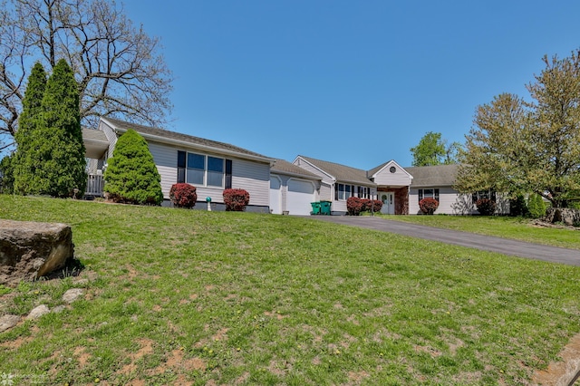 ranch-style home with a garage, driveway, and a front yard