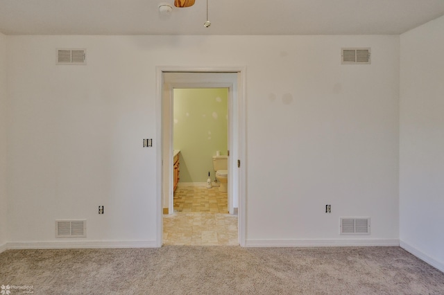 unfurnished room featuring carpet flooring and visible vents