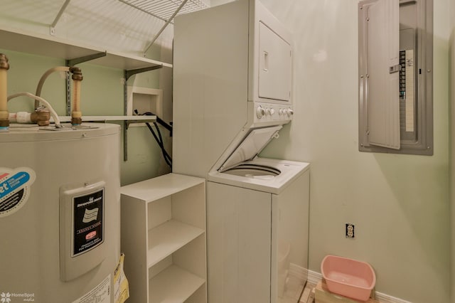 laundry area featuring electric panel, laundry area, stacked washer and dryer, baseboards, and electric water heater