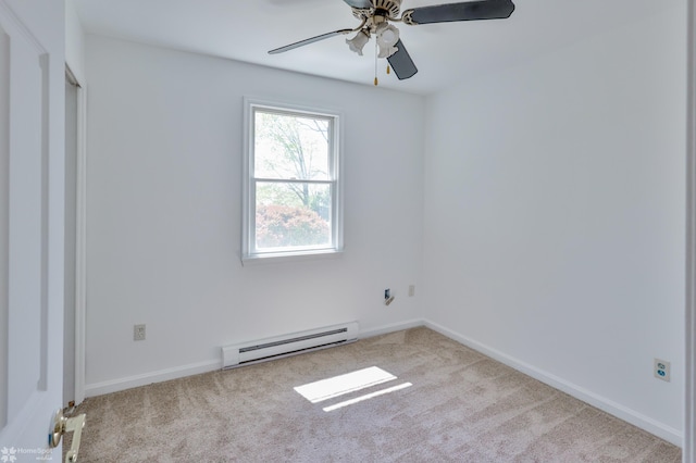 carpeted empty room with baseboards, a baseboard radiator, and a ceiling fan