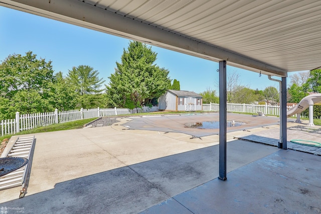 view of patio / terrace featuring an outdoor structure, a fenced in pool, and fence private yard