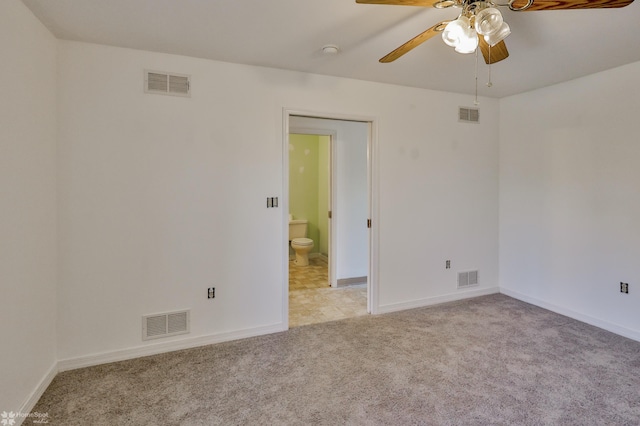 spare room with visible vents and ceiling fan