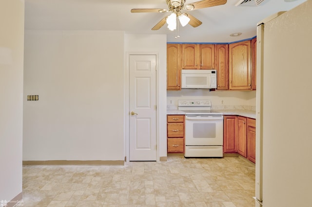 kitchen featuring brown cabinetry, white appliances, baseboards, ceiling fan, and light countertops
