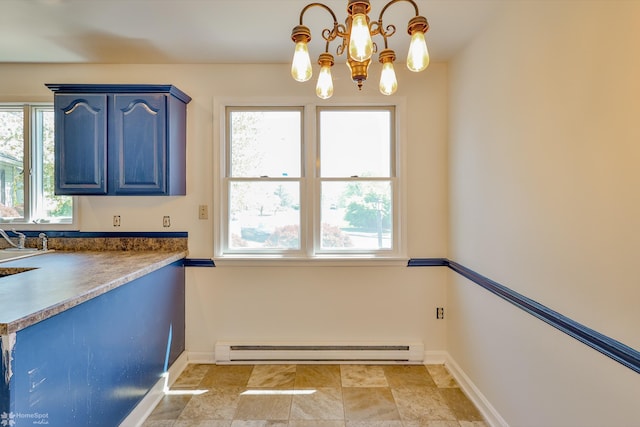 kitchen featuring baseboards, blue cabinets, a notable chandelier, and baseboard heating