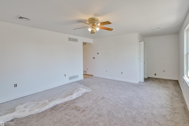 empty room with a ceiling fan and visible vents
