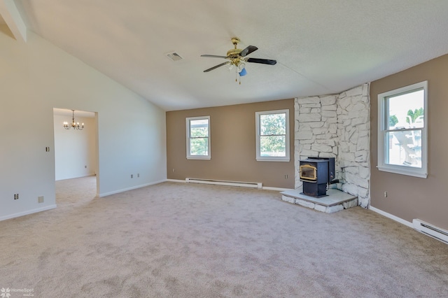 unfurnished living room with visible vents, a wood stove, ceiling fan with notable chandelier, a baseboard heating unit, and vaulted ceiling with beams