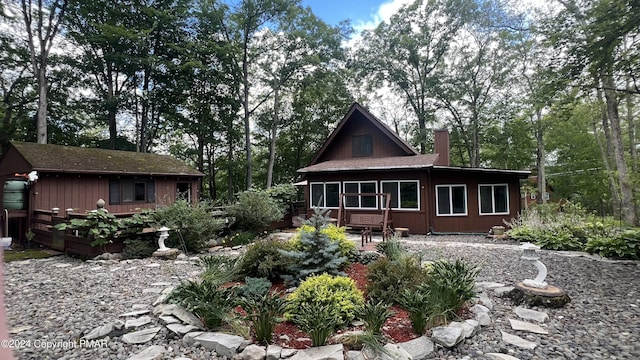 rear view of property featuring a sunroom