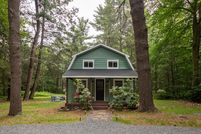 235 3rd St, Pocono Pines, PA 18350 - dutch colonial featuring a gambrel roof, covered porch, and roof with shingles