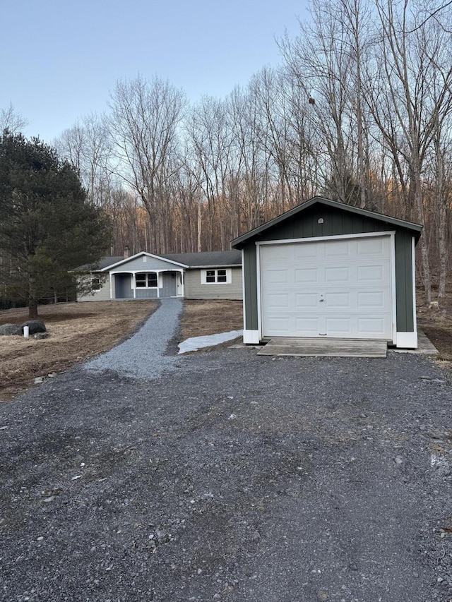 view of front facade featuring board and batten siding and gravel driveway