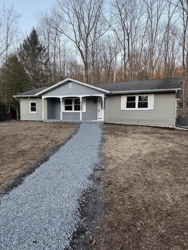 single story home with cooling unit and driveway