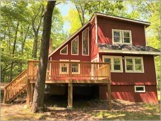 back of property with stairs and a wooden deck