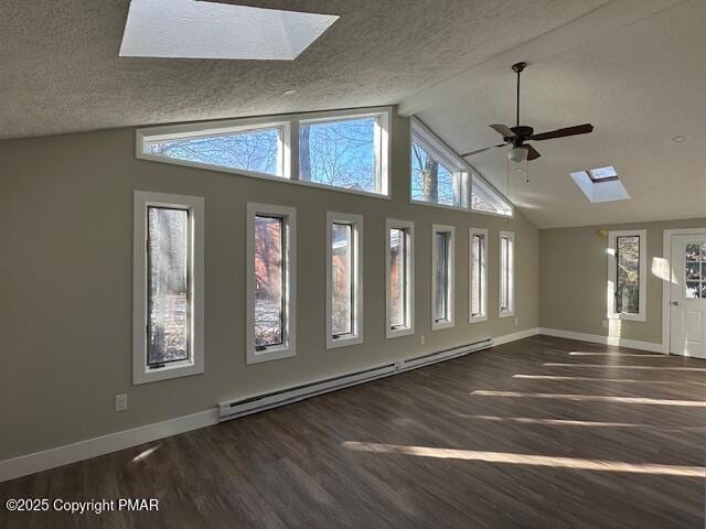 unfurnished living room featuring a skylight, baseboards, a baseboard radiator, wood finished floors, and a textured ceiling