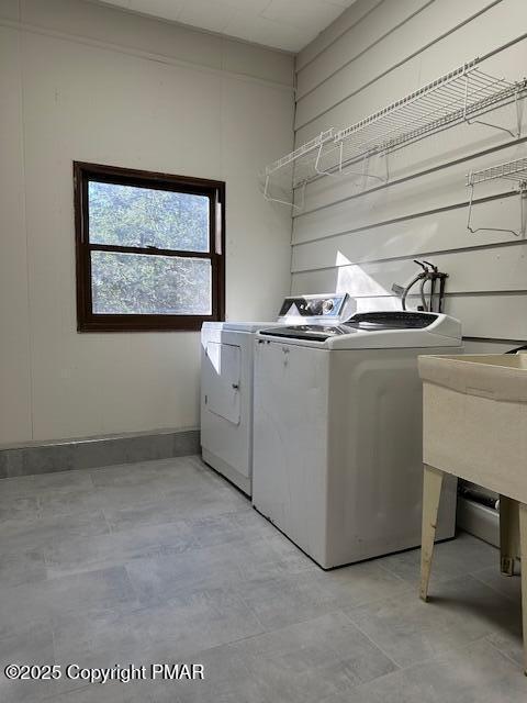 clothes washing area featuring laundry area and washing machine and dryer