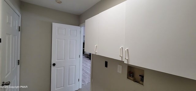 laundry room featuring hookup for a washing machine and cabinet space