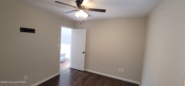 unfurnished room featuring baseboards, ceiling fan, and dark wood-style flooring