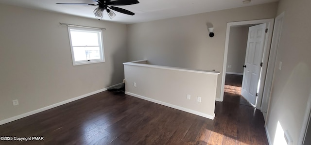 unfurnished room featuring wood finished floors, baseboards, and ceiling fan