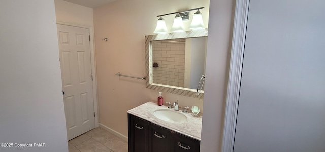 bathroom featuring tile patterned floors, baseboards, and vanity