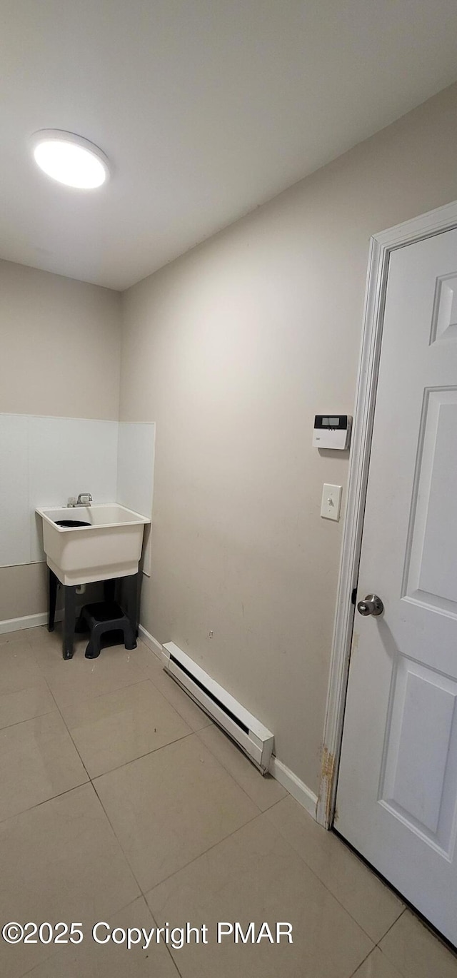 bathroom with tile patterned flooring, baseboards, and a baseboard radiator