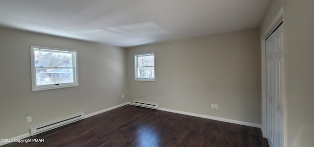 unfurnished bedroom with dark wood-type flooring, baseboards, and a baseboard radiator