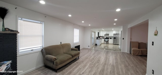 living room with plenty of natural light and light wood-type flooring