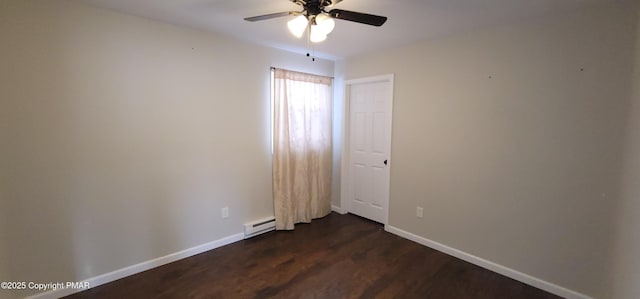 unfurnished room with a baseboard heating unit, baseboards, dark wood-style floors, and a ceiling fan