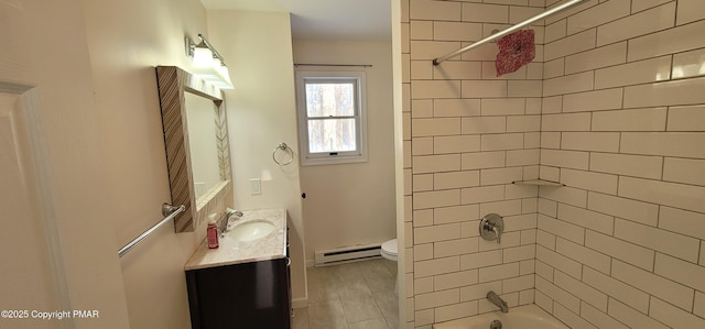 full bath with vanity, toilet, a baseboard heating unit, and washtub / shower combination