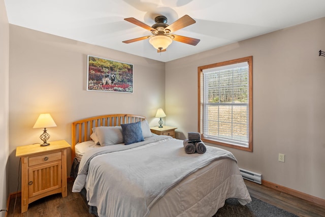 bedroom with ceiling fan, a baseboard heating unit, baseboards, and dark wood-style flooring