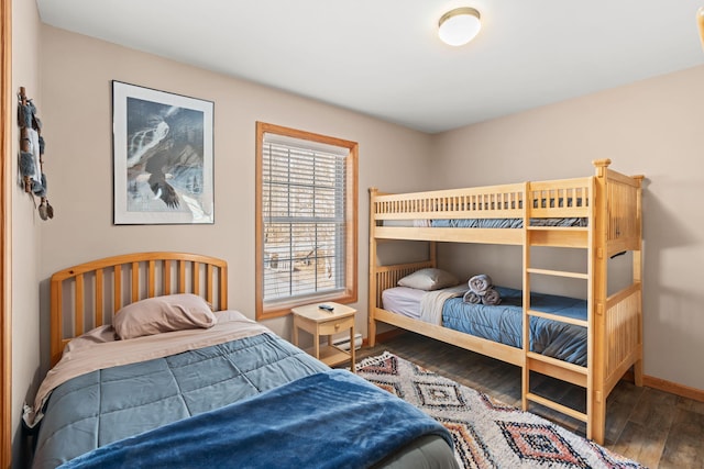 bedroom featuring baseboards and hardwood / wood-style flooring