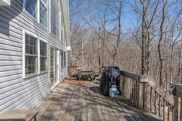 wooden terrace featuring a grill