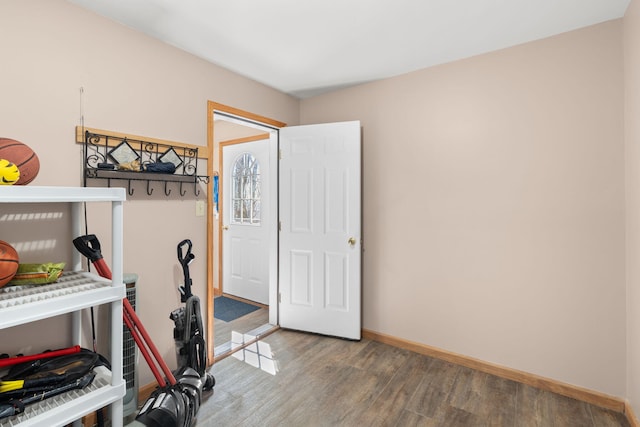 interior space featuring wood finished floors and baseboards