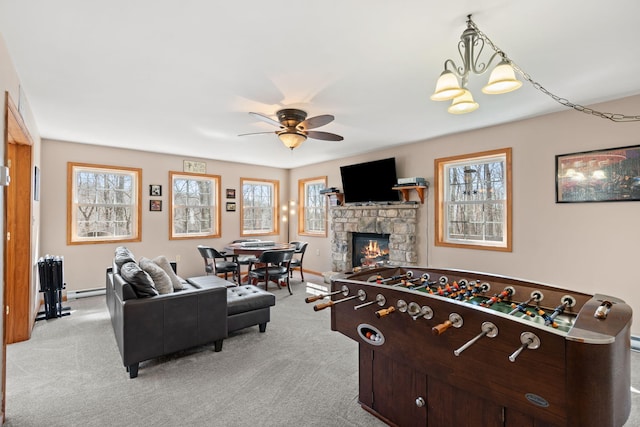 game room featuring carpet flooring, ceiling fan with notable chandelier, and a wealth of natural light