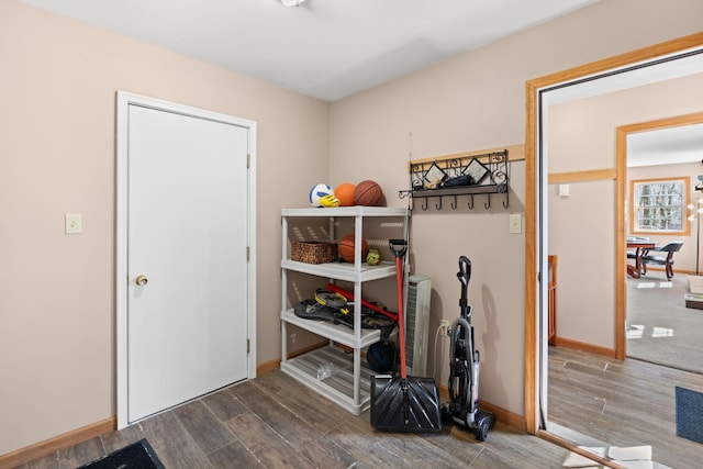 interior space with baseboards and wood finished floors