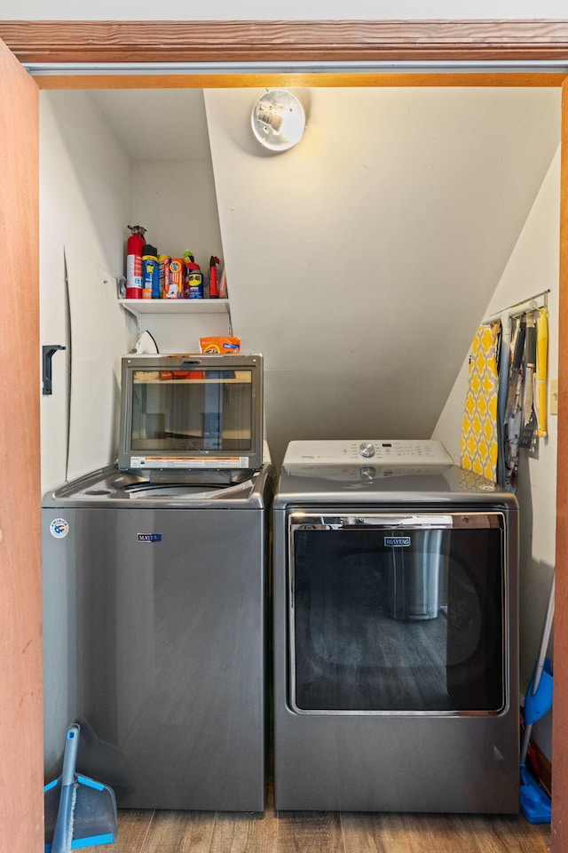 laundry area featuring wood finished floors and washing machine and dryer