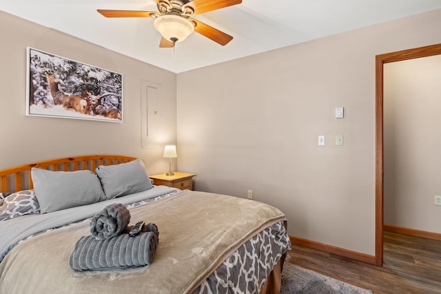 bedroom featuring wood finished floors, baseboards, and ceiling fan