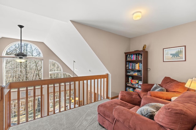 living area with vaulted ceiling, carpet flooring, and a ceiling fan