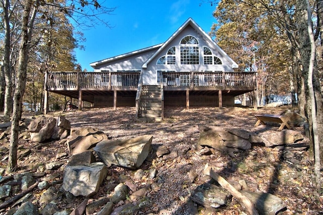 rear view of property featuring stairway and a wooden deck