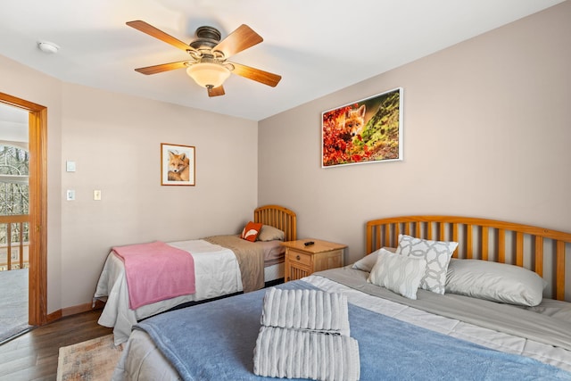 bedroom featuring baseboards, wood finished floors, and a ceiling fan